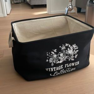 Large fabric basket with handles for storage.